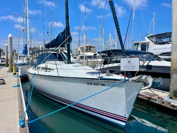 C&C 121 Sailboat docked at marina, C&C 121 model, 2005, with blue sky background.