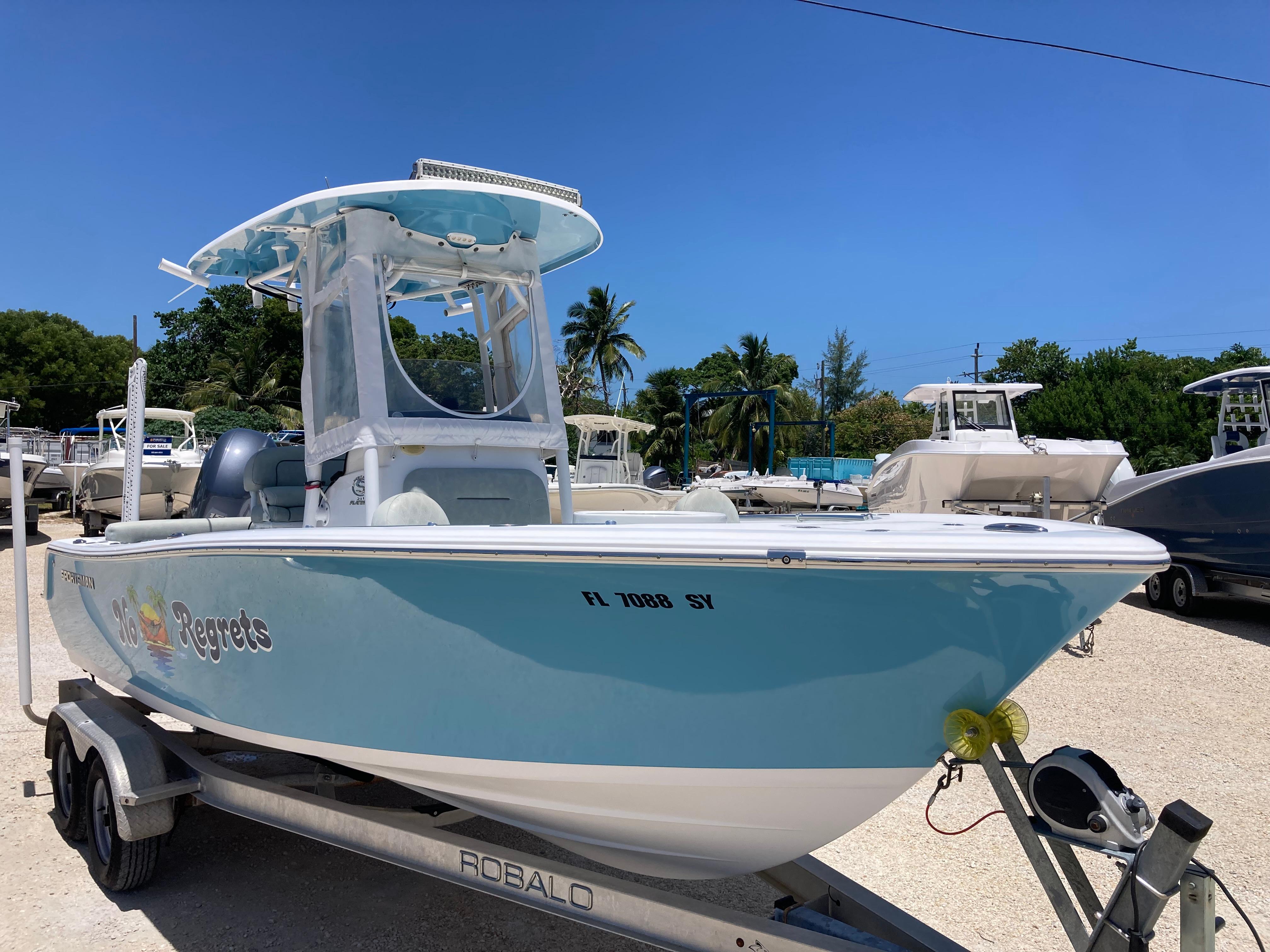 Sportsman Heritage 211 Center Console 2019 Sportsman Heritage 211 Center Console boat on trailer, sunny day, palm trees in background.