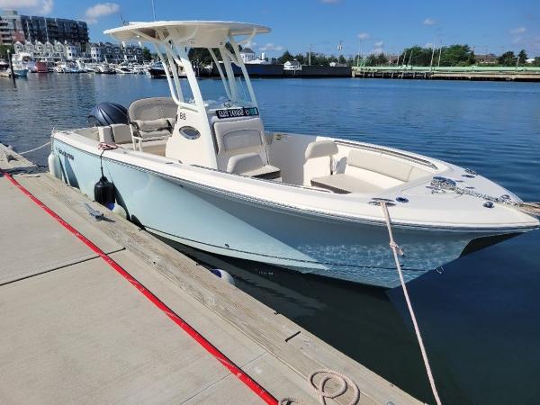 Sailfish 241 CC 2023 Sailfish 241 CC boat docked at a marina on a sunny day.