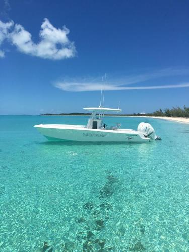 Contender 28 Sport 2016 Contender 28 Sport boat in clear turquoise water under a bright blue sky.