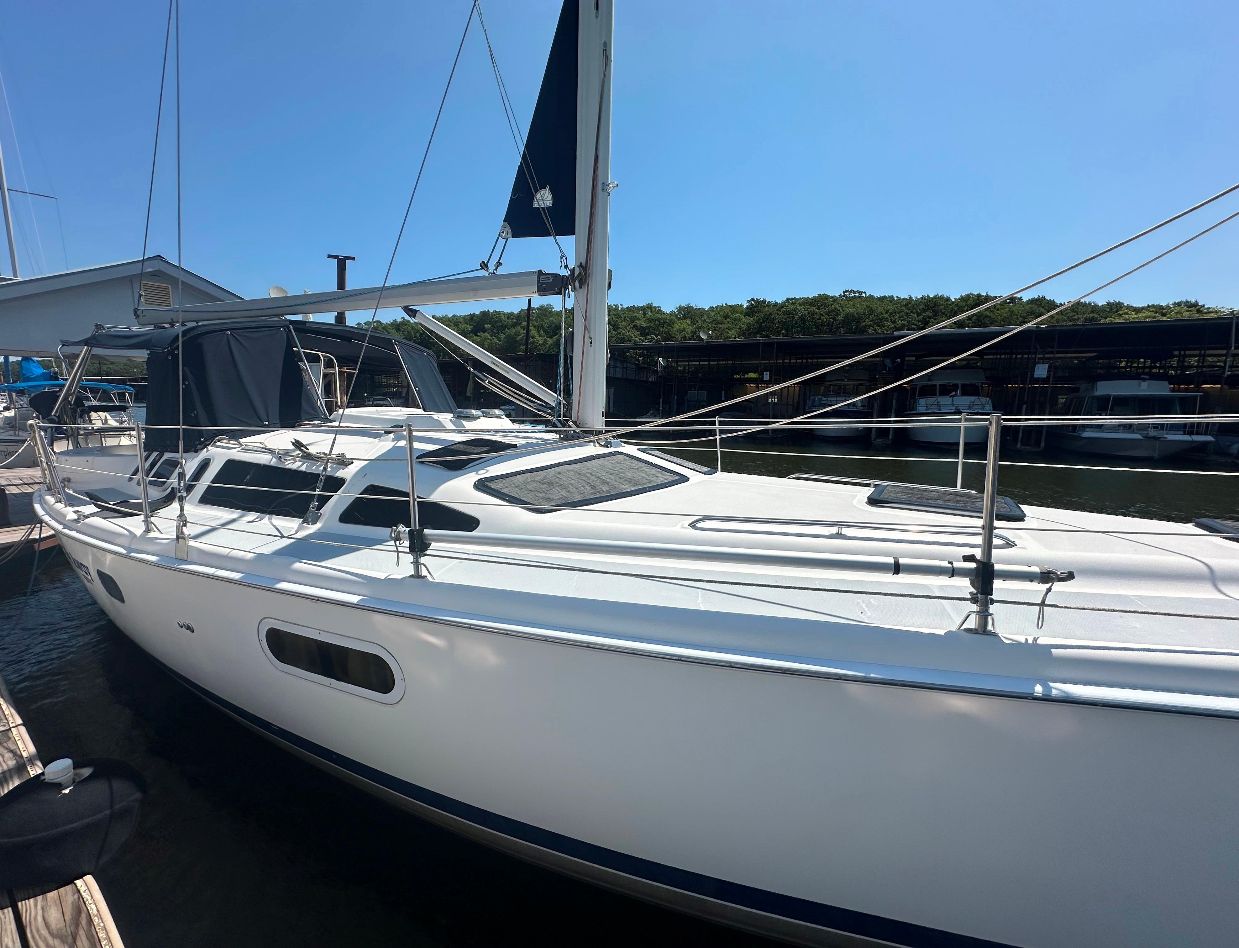 Hunter 410 Sailboat docked at marina, 2002 Hunter 410 model, clear blue sky background.