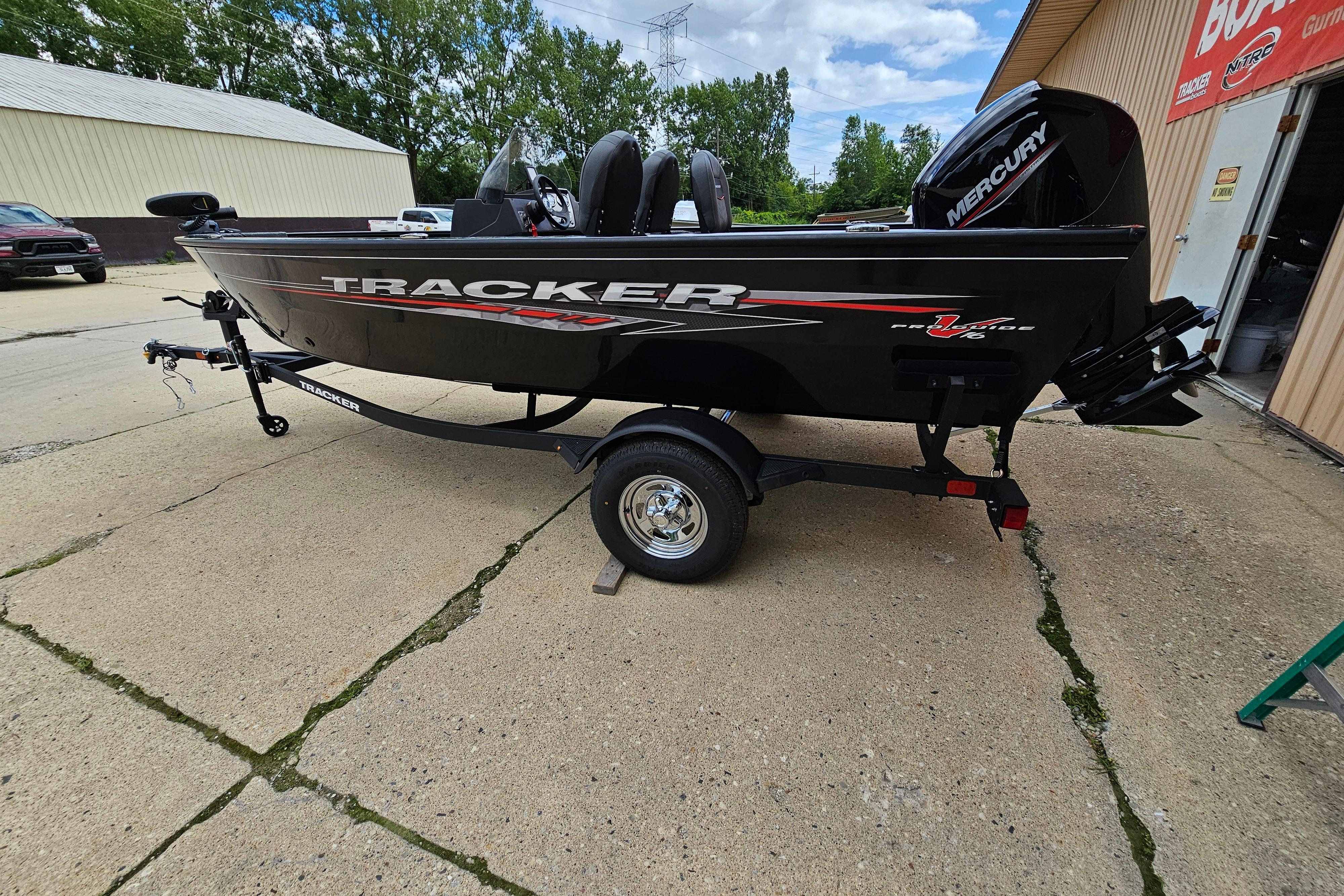 Tracker Pro Guide V-16 SC 2026 Tracker Pro Guide V-16 SC boat on trailer, parked outdoors.