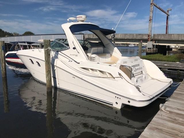 Sea Ray 330 Sundancer 2009 Sea Ray 330 Sundancer yacht docked at marina under clear sky.