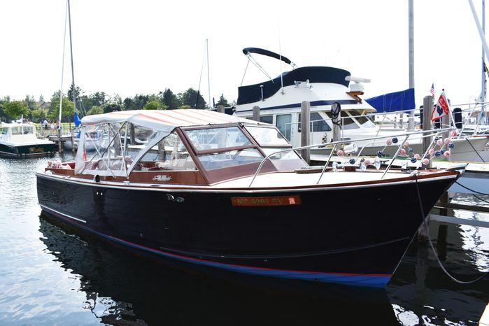 Chris-Craft Sea Skiff 1960 Chris-Craft Sea Skiff boat docked at marina, featuring classic wooden design and clear canopy.