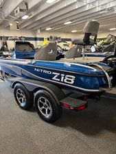 Nitro Z18 Pro 2024 Nitro Z18Pro boat in showroom, blue exterior, dual seats, trailer attached.