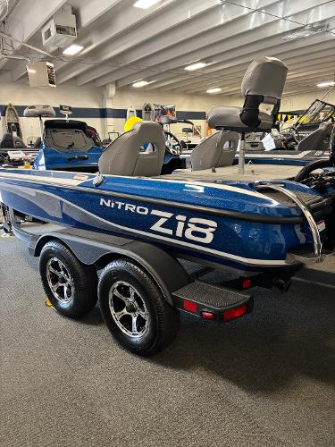 Nitro Z18Pro 2024 Nitro Z18Pro boat in showroom, blue exterior, dual seats, trailer attached.