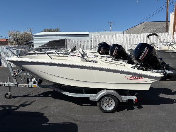 Boston Whaler 130 Super Sport 2025 Boston Whaler 130 Super Sport boat on trailer, parked outdoors.