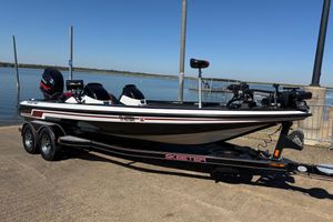 Skeeter ZX250 2011 Skeeter ZX250 boat on trailer by a lake, ready for launch.