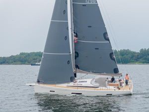 Italia Yachts 12.98 2023 Italia Yachts 12.98 sailing on calm waters with lush greenery in the background.
