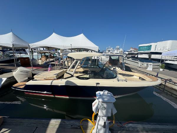Chris-Craft Sportster 28 2026 Chris-Craft Sportster 28 boat docked at marina under clear blue sky.