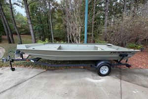 Tracker Grizzly 1754 Utility 2026 Tracker Grizzly 1754 Utility boat on trailer, parked in wooded area.