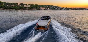 Marian M800 Spyder 2024 Marian M800 Spyder cruising on water at sunset near a scenic coastline.