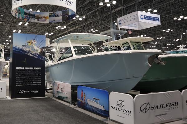 Sailfish 276 DC 2024 Sailfish 276 DC boat displayed at an indoor exhibition with promotional banners.