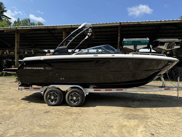 Chaparral 247 SSX 2025 Chaparral 247 SSX boat on trailer, parked outdoors under clear sky.