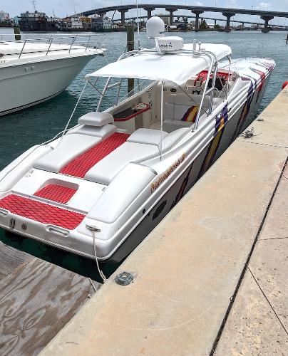Nor-Tech 500 2001 Nor-Tech 500 boat docked, featuring sleek design and vibrant red accents.