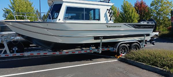Spartan 260 Maximus Pro XL 2025 Spartan 260 Maximus Pro XL boat on trailer in parking lot.