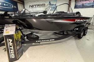 Tracker Targa V-18 WT 2026 Tracker Targa V-18 WT boat on display in showroom with trailer.