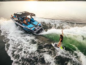 ATX Surf Boats 22 Type-S 2024 ATX Surf Boats 22 Type-S with people wake surfing on a lake.