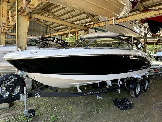 Chaparral 21 SSi 2025 Chaparral 21 SSi boat on trailer in covered storage area.