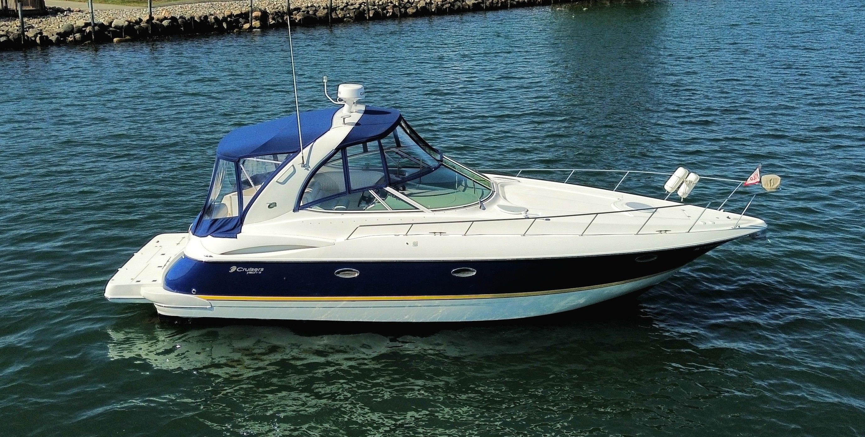 Cruisers Yachts 370 Express 2004 Cruisers Yachts 370 Express boat on calm water, side view.