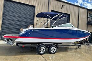 Four Winns SL262 2011 Four Winns SL262 boat with blue hull and red stripe on trailer.