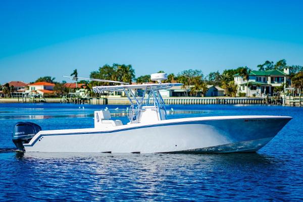 Invincible 33 Open Fisherman 2015 Invincible 33 Open Fisherman boat on calm water, clear blue sky background.