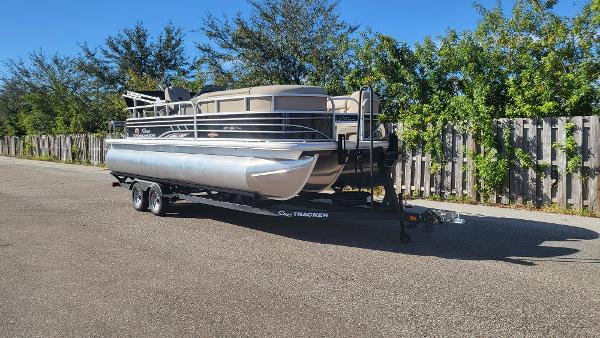 Sun Tracker SportFish 22 XP3 2023 Sun Tracker SportFish 22 XP3 pontoon boat on trailer, parked outdoors.