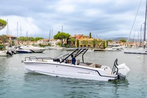 Axopar 25 Cross Top 2024 Axopar 25 Cross Top boat cruising in a marina with scenic background.