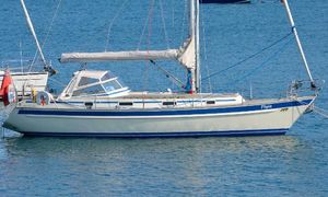 Malo 39 Sailboat Malo 39, 1997 model, anchored on calm blue water.