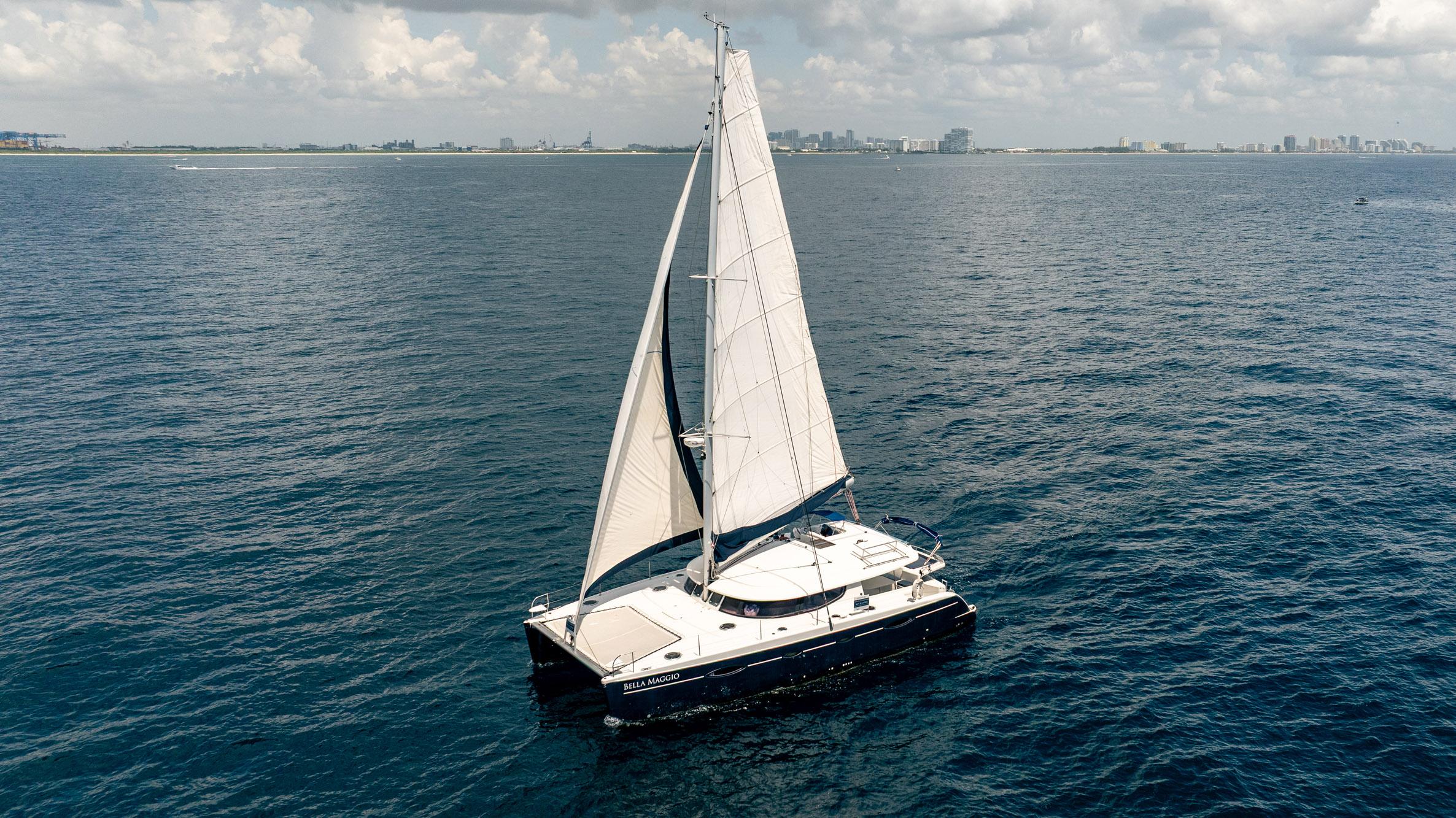 Fountaine Pajot Salina 48 Evolution Sailing catamaran Fountaine Pajot Salina 48 Evolution, 2008, on open sea with city skyline.