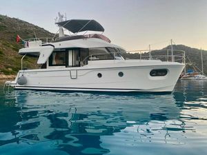 Beneteau Swift Trawler 41 Fly 2021 Beneteau Swift Trawler 41 Fly on serene water, scenic backdrop.