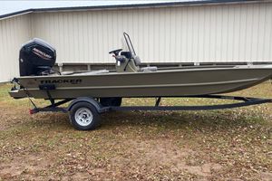 Tracker Grizzly 1860 CC 2026 Tracker Grizzly 1860 CC boat on trailer, parked outdoors near a building.