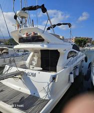 Astondoa 43 GLX 2005 Astondoa 43 GLX yacht docked at marina, rear view, sunny day.