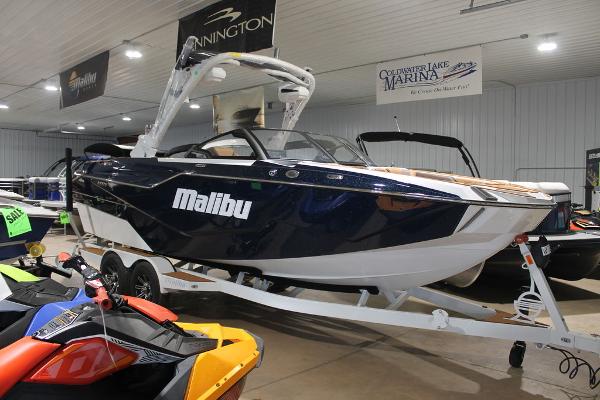 Malibu M230 2025 Malibu M230 boat displayed indoors on a trailer.