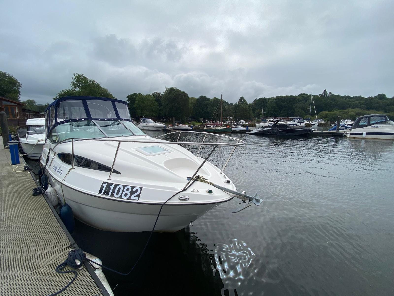 Bayliner 245 2010 Bayliner 245 boat docked at a marina on a cloudy day.