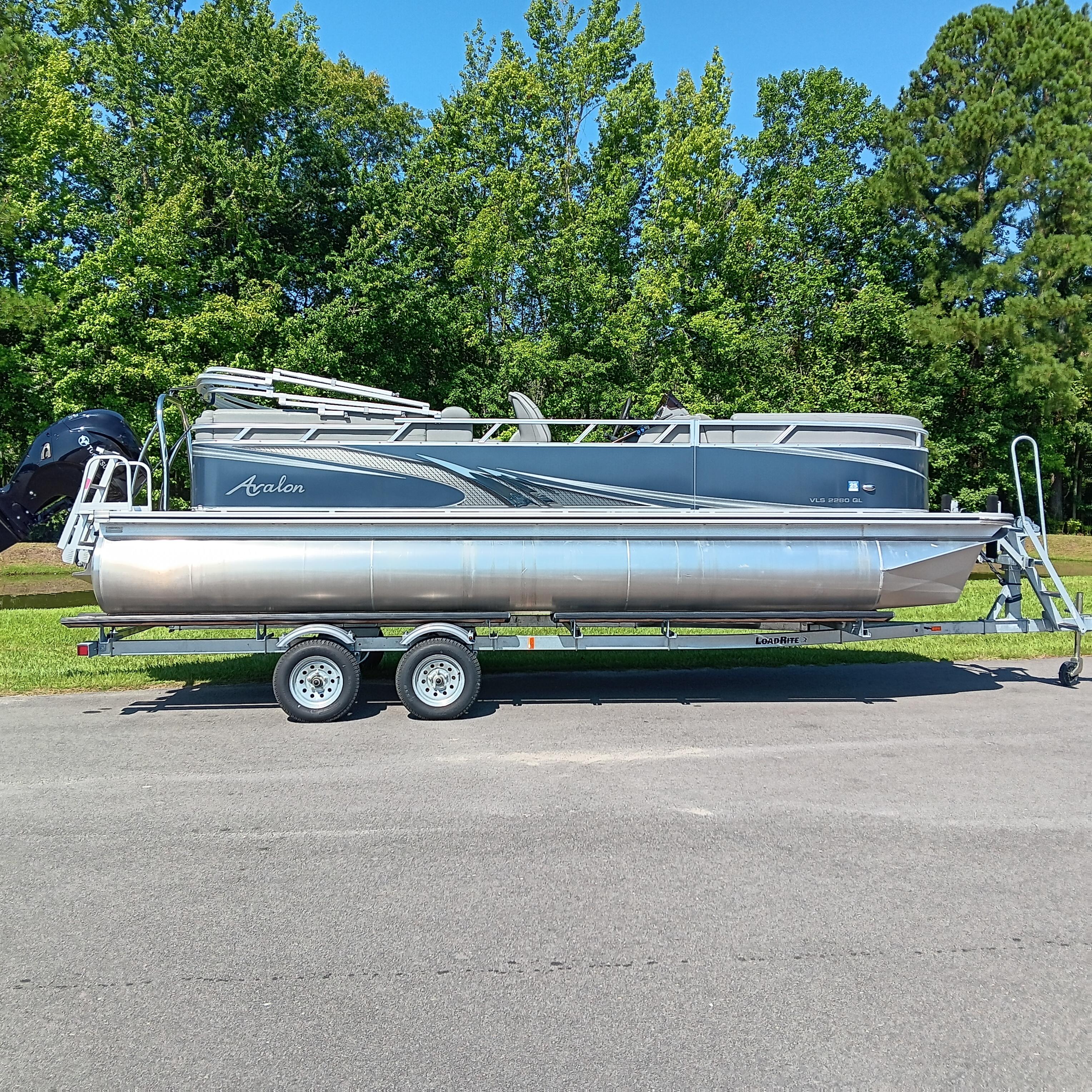 Avalon VLS Quad Lounge 2022 Avalon VLS Quad Lounge pontoon boat on trailer, parked outdoors.