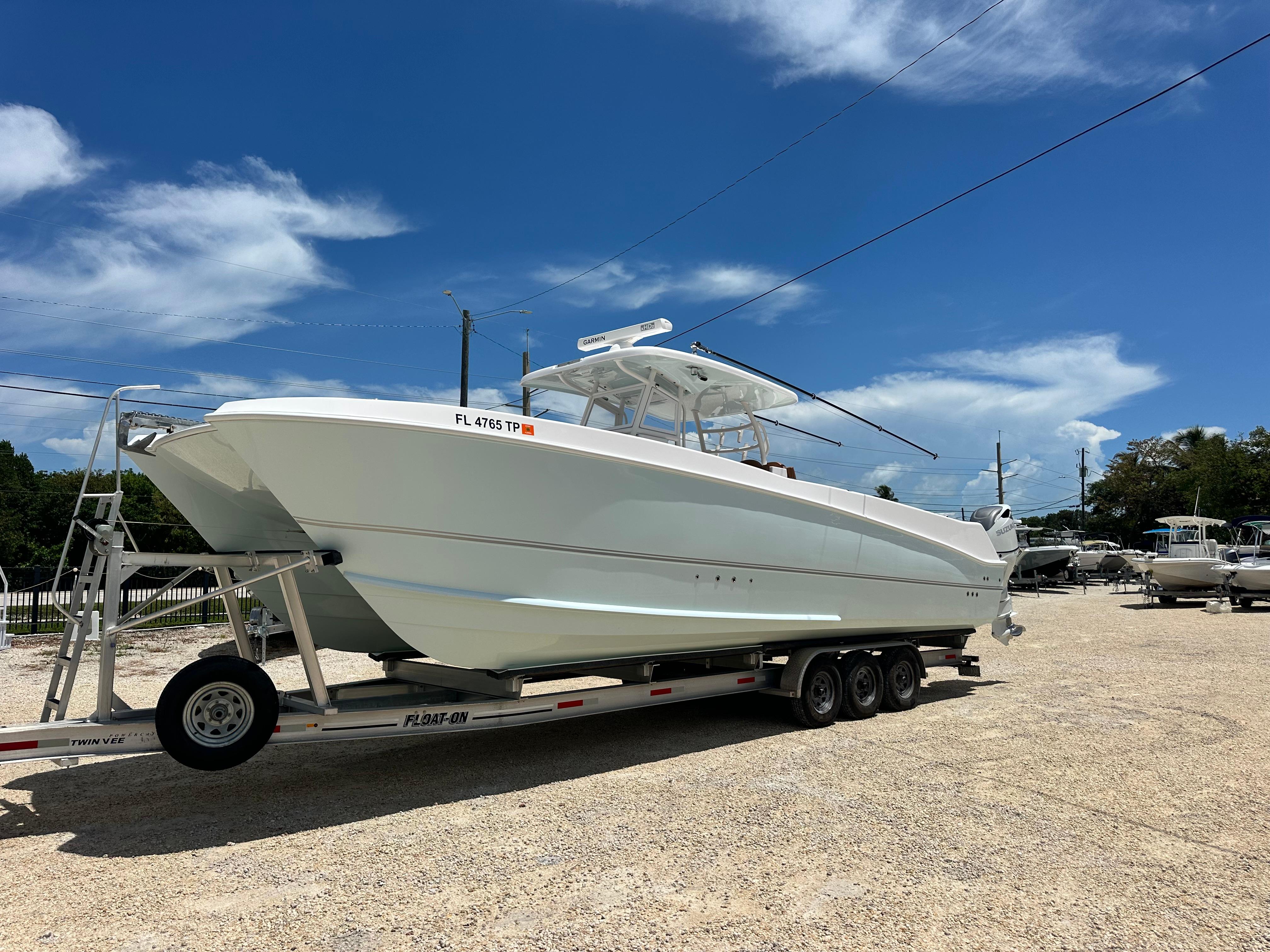 Twin Vee 340 GFX CC 2023 Twin Vee 340 GFX CC boat on trailer under clear blue sky.