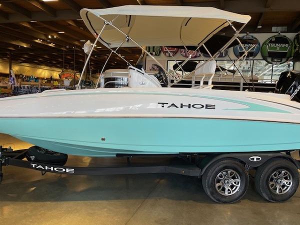 Tahoe 2150 CC 2025 Tahoe 2150 CC boat with canopy on trailer in showroom.