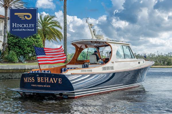 Hinckley Picnic Boat 37 MKIII 2017 Hinckley Picnic Boat 37 MKIII on water, American flag, "Miss Behave" nameplate.