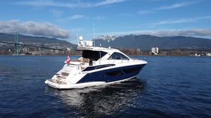 Regal 53 Sport Coupe 2017 Regal 53 Sport Coupe yacht on water with mountains and bridge in background.