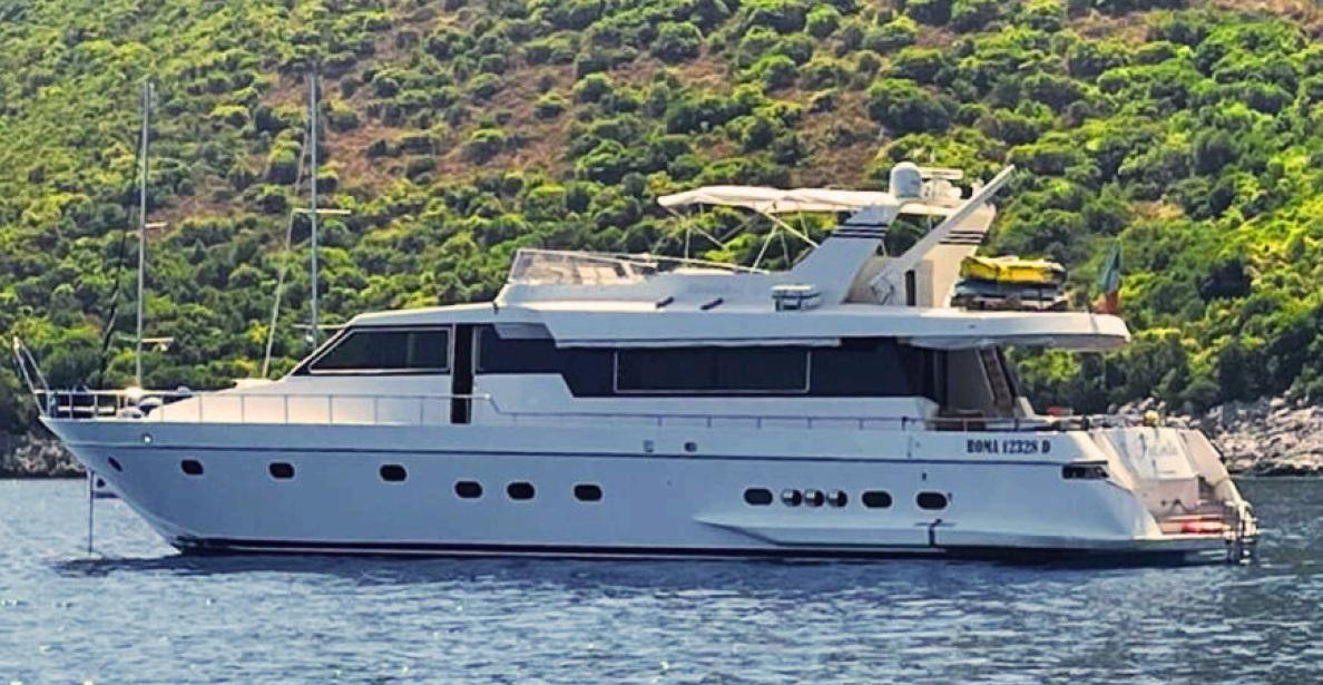 Canados Motor Yacht 1991 Canados Motor Yacht on calm water with lush green hillside background.