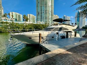 Viking Princess 61 Luxury 2005 Viking Princess 61 yacht docked in urban marina setting.