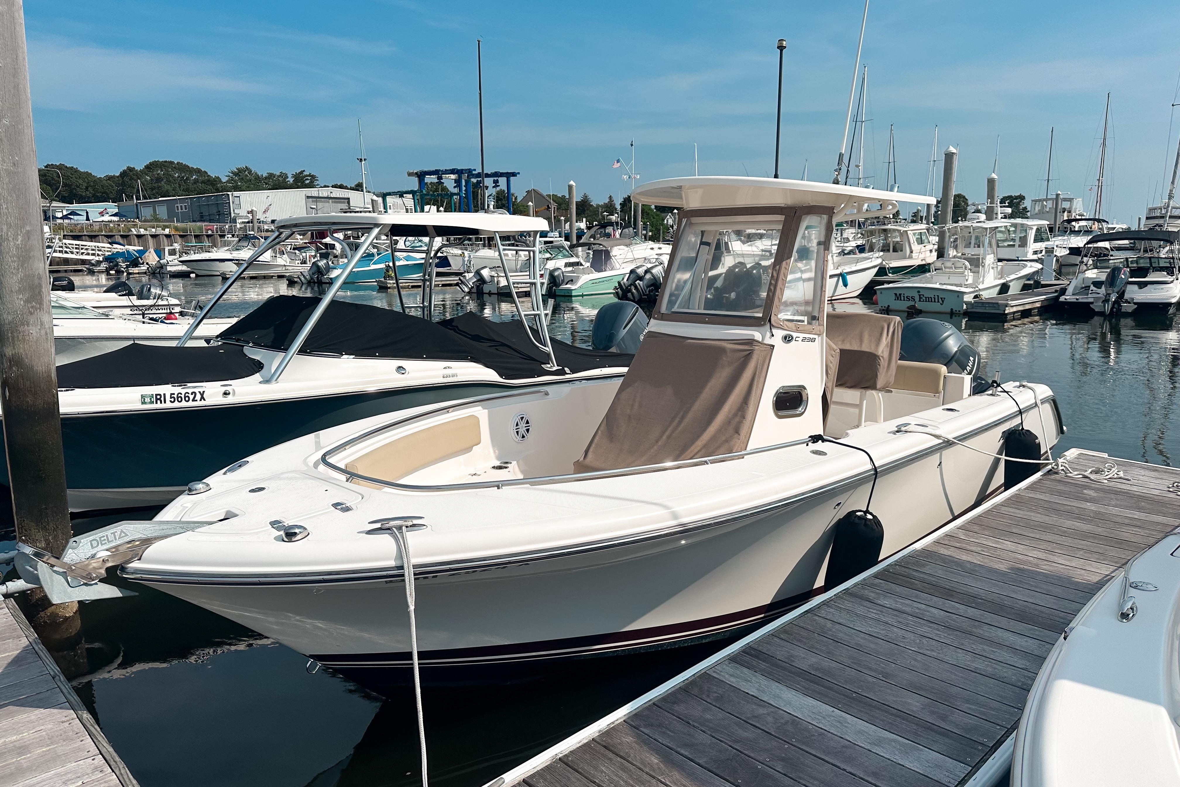 Pursuit C 238 Center Console 2016 Pursuit C 238 Center Console boat docked at marina, surrounded by other vessels.