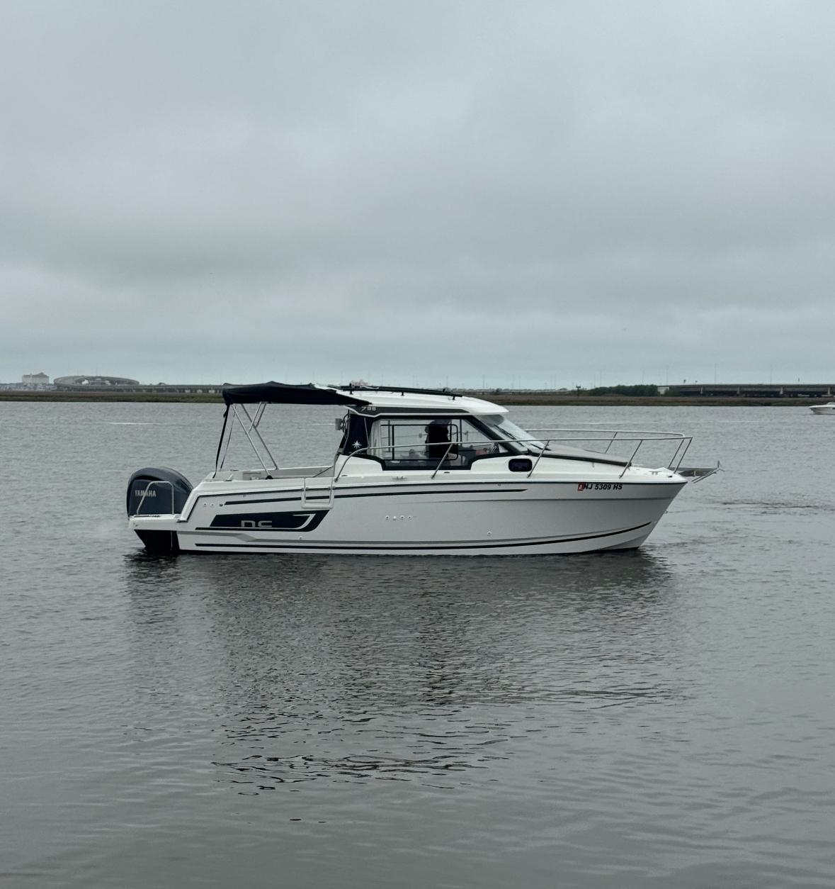 Jeanneau NC 795 Series 2 2024 Jeanneau NC 795 Series 2 boat on calm water, side view.