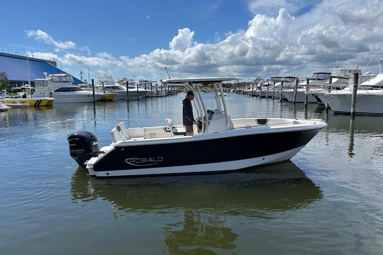 Robalo R230 Center Console 2020 Robalo R230 Center Console boat docked in a marina under a cloudy sky.