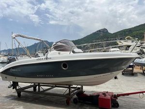 Idea IDEA 58WA 2024 Idea 58WA boat on trailer, dockside with scenic mountain backdrop.