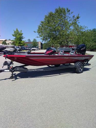 Ranger RT188 2024 Ranger RT188 boat in a parking lot, featuring a sleek red design.