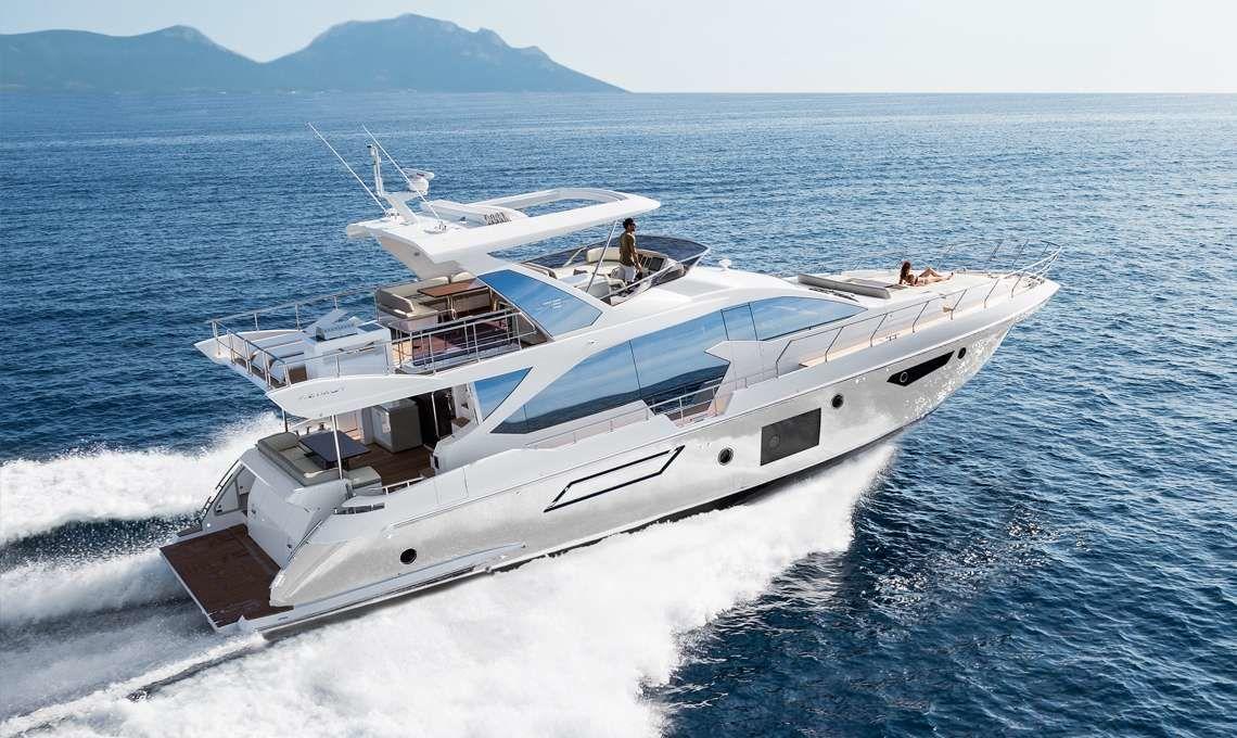 Azimut Fly 72 Luxurious 2019 Azimut Fly 72 yacht cruising on open sea with scenic mountain backdrop.