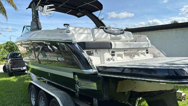 Chaparral 30 Surf 2021 Chaparral 30 Surf boat on trailer, parked outdoors, showcasing sleek design and modern features.