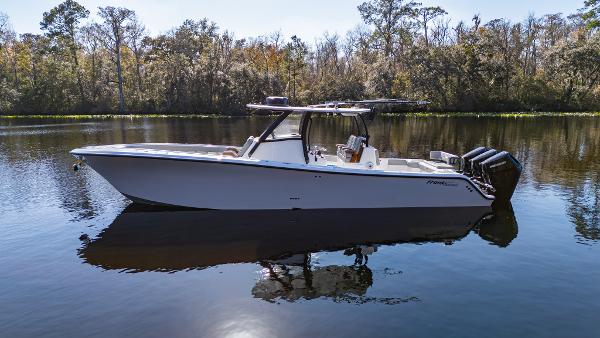 Front Runner 36 Center Console 2026 Front Runner 36 Center Console boat on calm water, surrounded by trees.